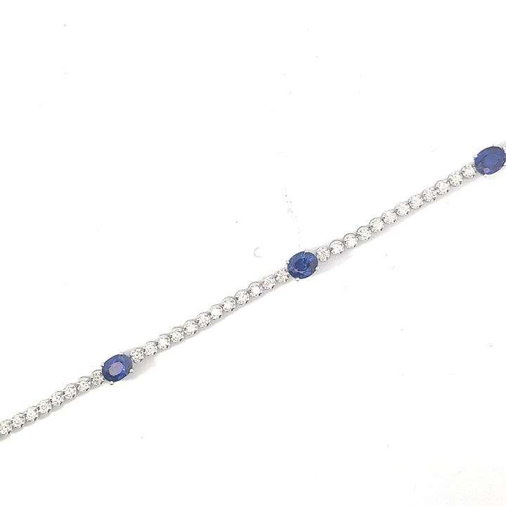 top-down view of the diamond tennis bracelet with sapphires
