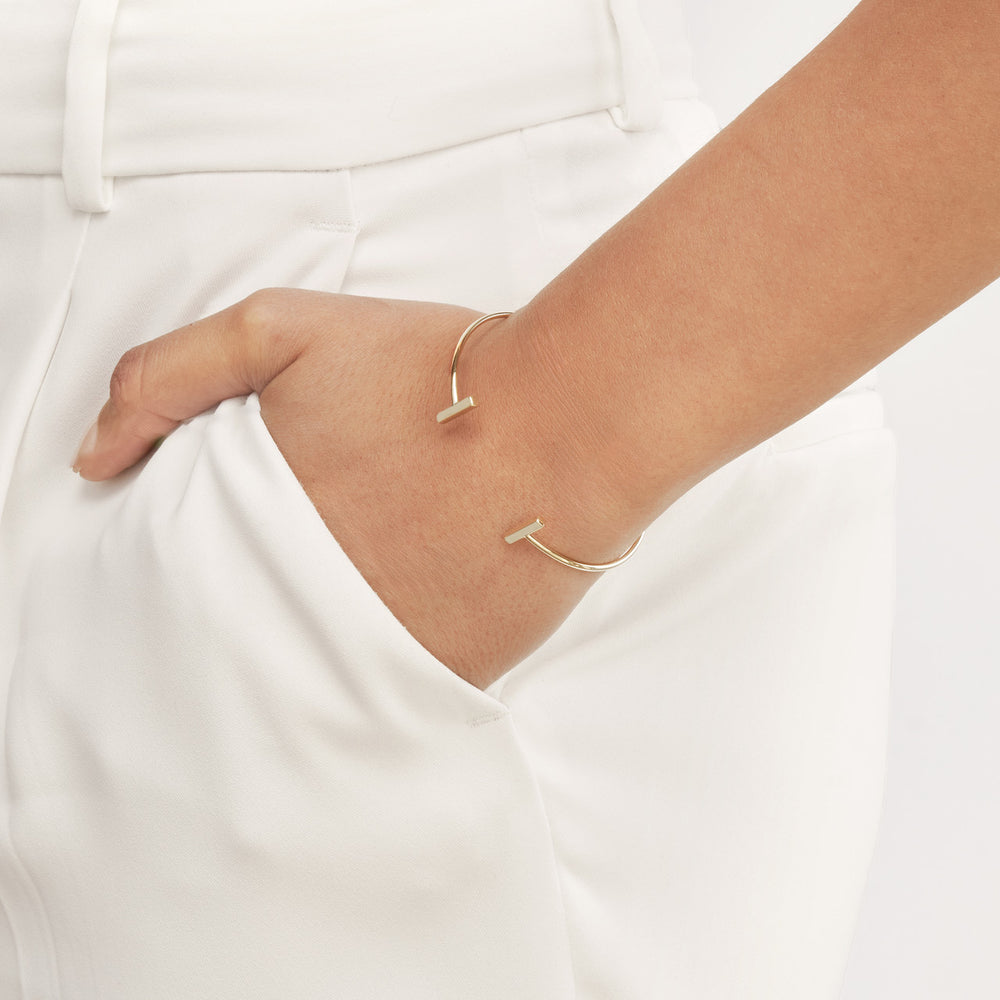 woman wearing the Staple Bar Cuff Bangle with her hand in her pocket