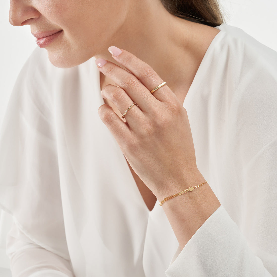 The 50/50 Paper Clip + Double Rolo Heart Bracelet from Olas d'Oro is a perfect blend of style and love.