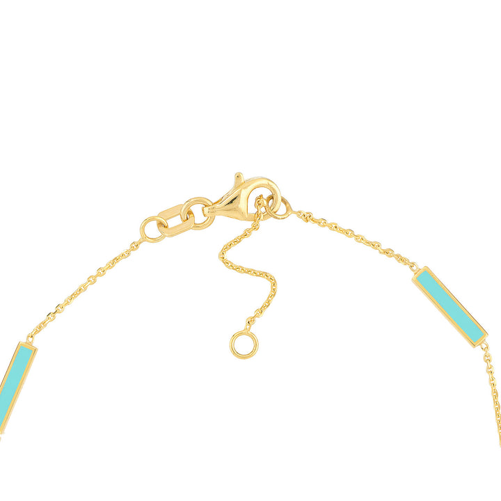 close up of the yellow gold adjustable clasp and turquoise enamel bars
