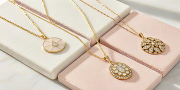 Custom gold jewelry pendants on chains for a Mother's Day gift.