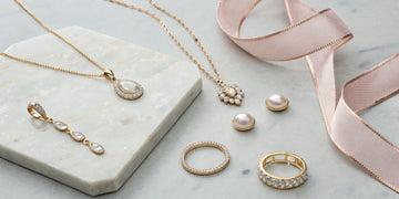 Luxury jewelry gifts for Mother's Day, featuring pearl earrings, diamond rings, and gold necklaces.