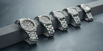 A collection of Rolex Daytona watches with vibrant color diamond bezels.