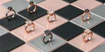 A collection of black and rose gold engagement rings featuring black and white diamonds.