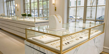 A high-end jewelry store with display cases showcasing luxury wedding bands.