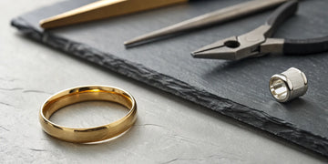 The cost to repair a bent ring, shown with the necessary jeweler's tools.