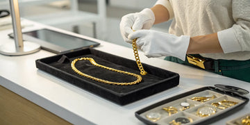 A jeweler evaluates a gold necklace to find the best place to sell for top cash.