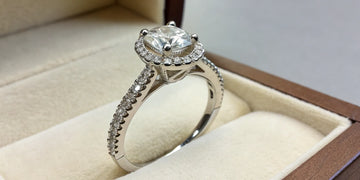 Custom engagement ring design with a round center diamond and pavé band.