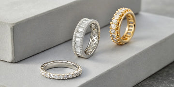 Sparkling diamond eternity bands for her in white gold, platinum, and yellow gold.