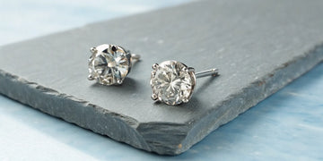 A pair of 2.0 carat round brilliant diamond stud earrings in a white gold setting.
