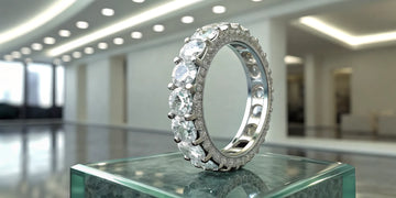 A round diamond eternity band engagement ring in a platinum setting.