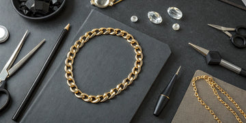 A gold chain and jeweler's tools used to assess the repair cost.