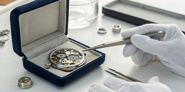 A watchmaker servicing a watch, a process that takes time and careful precision.