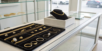 Gold jewelry being weighed at a pawn shop to see how much they pay for gold.