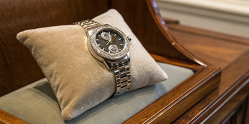 A Rolex watch showcased within an authorized dealer's display case.