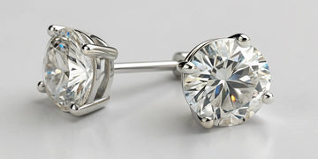 1 carat diamond stud earrings for women with round brilliant cut in white gold prong setting.