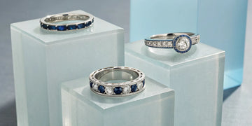 Channel and pavé set diamond and sapphire anniversary bands in white gold.