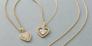 A variety of sparkling gold diamond heart necklaces.