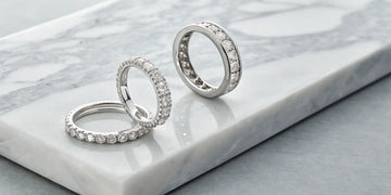 Two different styles of platinum wedding eternity rings.
