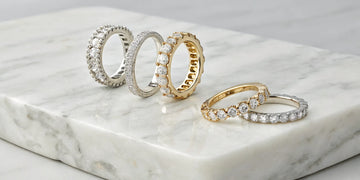 Various styles of diamond eternity wedding bands in platinum and gold.