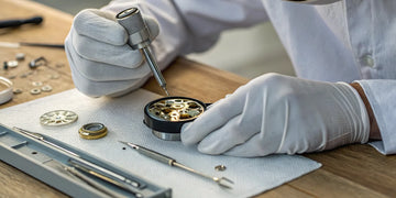 Watchmaker repairing a watch movement at the best watch repair shop in Oceanside.