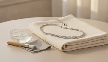 Pave diamond necklace with gentle cleaning tools on a linen cloth