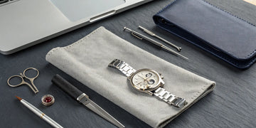 A watch and precision tools prepared for a professional watch restoration service.