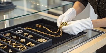 Selling antique gold jewelry to a local jeweler.