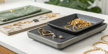 Broken gold jewelry, including rings and chains, laid out to sell for cash.