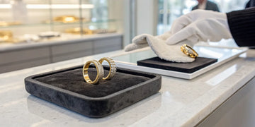 A collection of gold rings on a jeweler's tray to sell for top dollar.