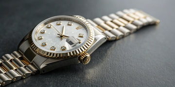 Rolex Datejust with a white diamond dial and two-tone bracelet.