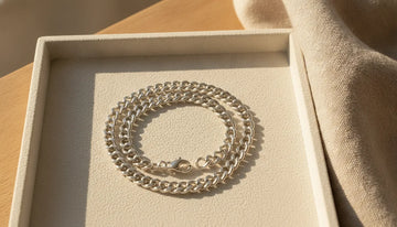 Polished silver bracelet on a neutral jewelry tray