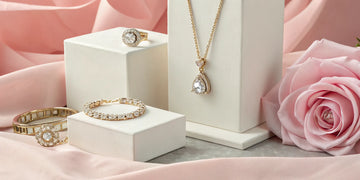 Gold and diamond jewelry for Mother's Day, including rings, bracelets, and a necklace with pink roses.