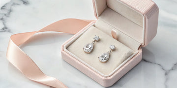 A Mother's Day gift of classic diamond earrings in a jewelry box.