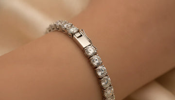 Close-up of a tennis bracelet showing articulated gemstone settings and clasp