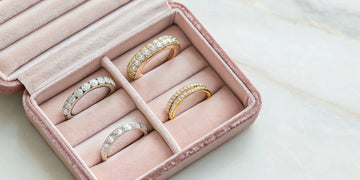 An assortment of custom wedding bands for her in gold and platinum with diamonds.