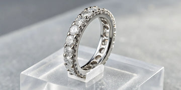 A modern floating diamond band with round diamonds set in a white gold setting.
