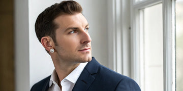 Man in a suit wearing classic diamond stud earrings for men.