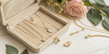 Several styles of gold necklaces for mom in a jewelry gift box.