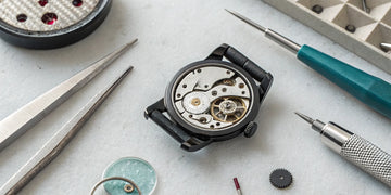 Close-up of a watch movement repair, a process that heavily influences the final cost.