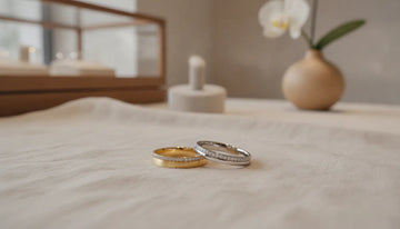 Elegant coordinated his and hers gold and platinum wedding bands in a boutique jewelry studio