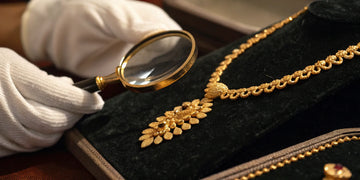 An expert appraising gold jewelry with a loupe to find the best place to sell for cash.