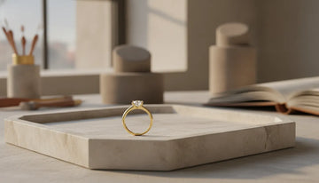 Gold band engagement ring displayed in a refined jeweler's studio