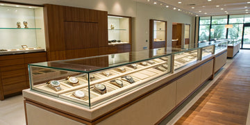 Authorized Rolex dealer showroom in Oceanside, NY, with watches in a glass display case.