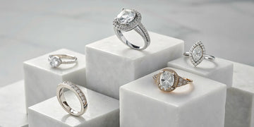 An assortment of luxury diamond engagement rings with different cuts and settings.