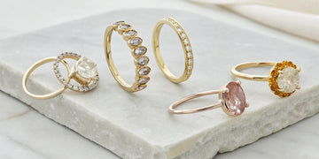 Personalized gold birthstone rings with names and custom engravings.