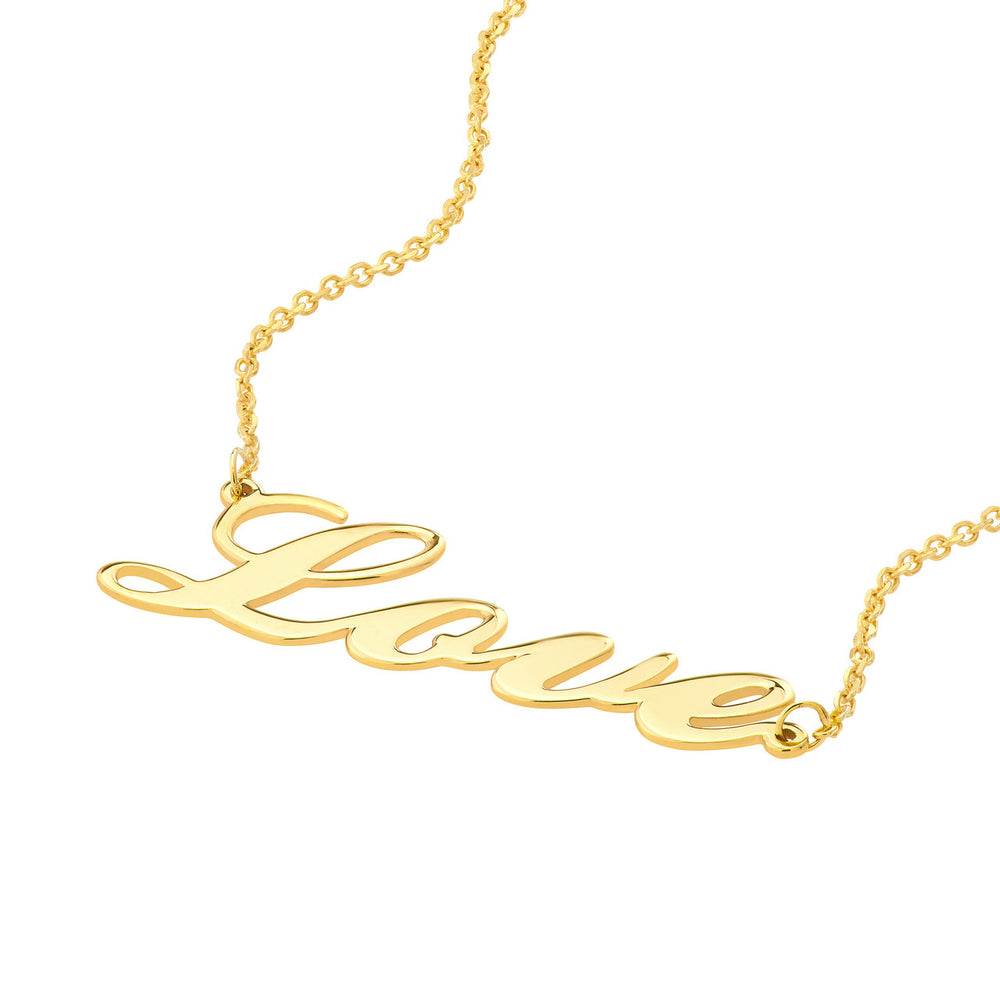 close up of the cursive love text charm on a yellow gold bracelet