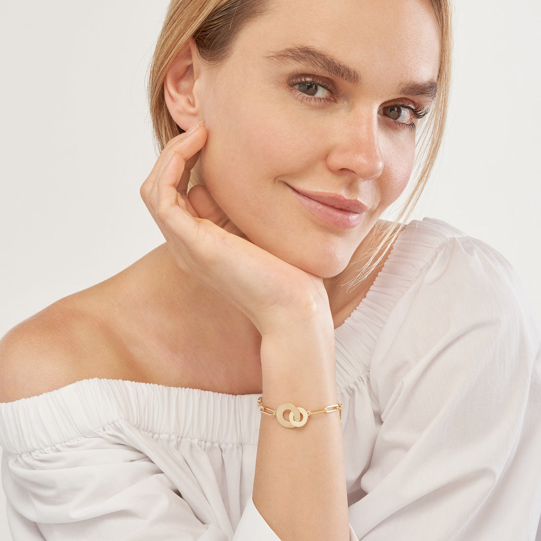 woman modeling the Interlocked Discs on Paper Clip Chain Bracelet on her wrist