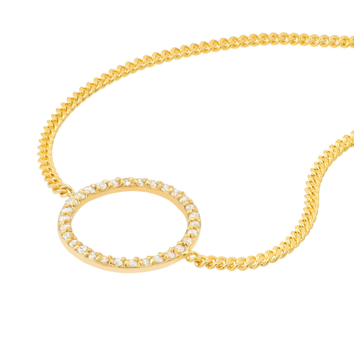 close up of the diamond circle connected to a yellow gold bracelet chain