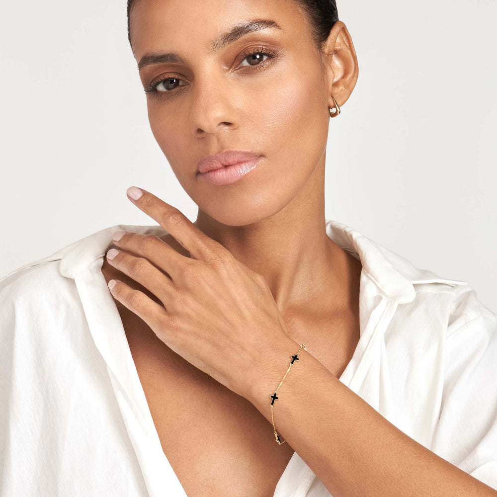woman modeling the black enamel sideways cross station bracelet
